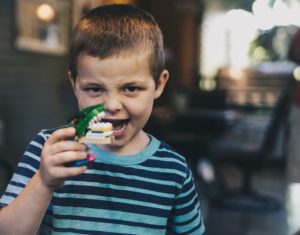 kid playing with logo toy