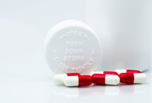 Pill bottle with pills spread across