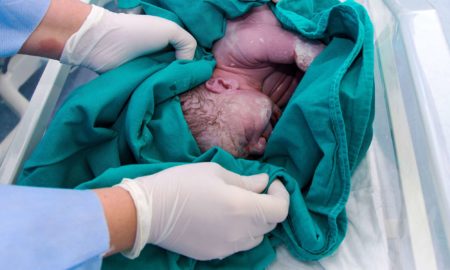 newborn being cleaned